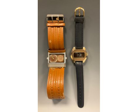 A 1960s Dynasty jump hour brushed metal and gilt cased wristwatch, black aperture, hour and minute registers, stainless steel