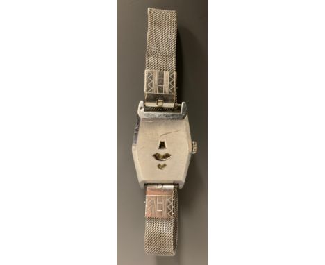 An Art Deco 1920/30s jump hour wristwatch, elongated hexagonal shaped silver coloured metal case, three viewing apertures, 40