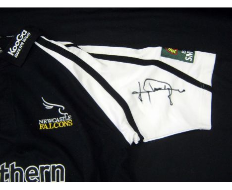 Packet containing Newcastle Falcons replica Rugby shirt signed by Johnny Wilkinson to the sleeve 
