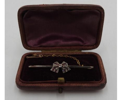 A DIAMOND AND RUBY SET BOW BROOCH 