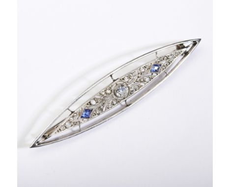 An early 20th century French platinum , diamond and sapphire brooch, the elliptical shaped panel centrally set with an old br