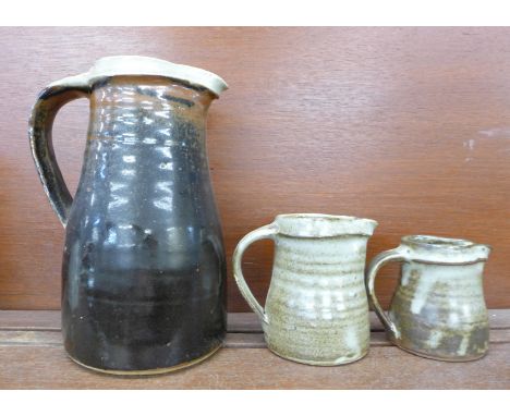 Three Bernard Leach pottery jugs, all three with small chips on the spouts, tallest 23.5cm 