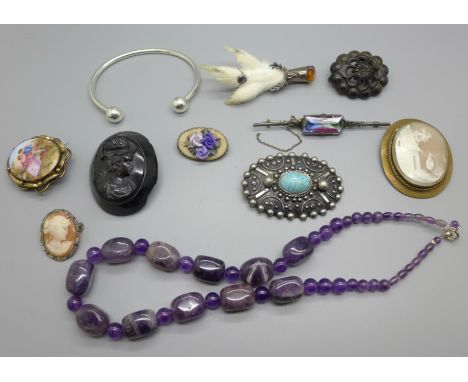 An amethyst bead necklace, a jet brooch a/f, other brooches and a torc bangle 
