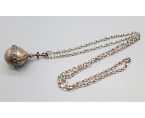 A hallmarked silver orb pendant set with a ruby and a silver chain, 31g 