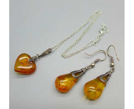A silver and amber pendant and chain and a pair of silver and amber earrings 