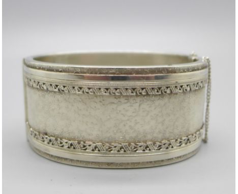 A c1900 silver bangle, marked sterling, 31mm wide 