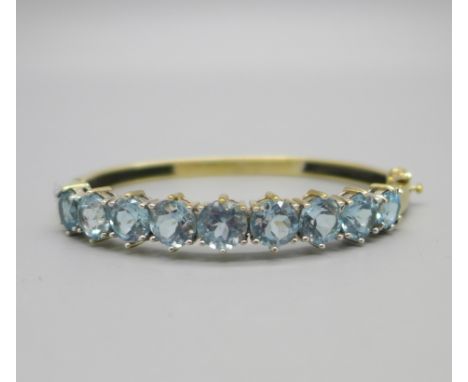 A silver gilt and aquamarine bangle 