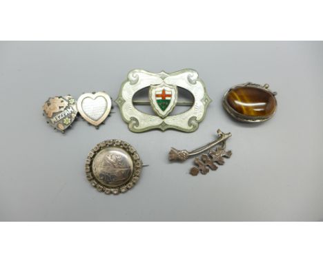 A silver and enamel brooch, a late Victorian silver Mizpah brooch lacking fastening hook and three other brooches, (thistle b
