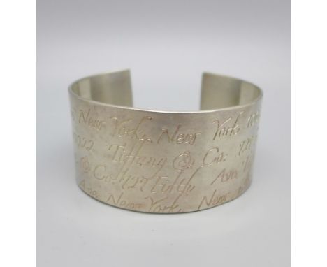 A Tiffany &amp; Co. 'Notes Script' sterling silver cuff bangle, 3cm wide, 45g 