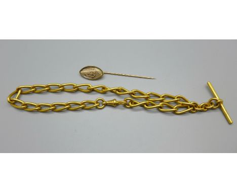 A circa 1900 yellow metal memorial pin and a gold tone Albert chain 