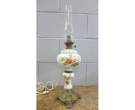 A glass floral pattern oil lamp 