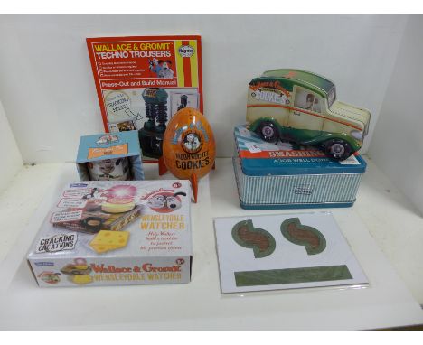 Wallace &amp; Gromit collectables:- two tins, mug, Techno Trousers Haynes manual, Wensleydale Watcher and Moon Rocket cookie 