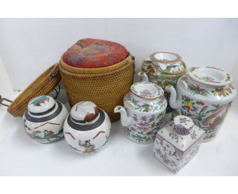 Three 19th Century Chinese Canton Famille Rose teapots, one with bamboo case, 15.5cm high without case, the other two 16cm an