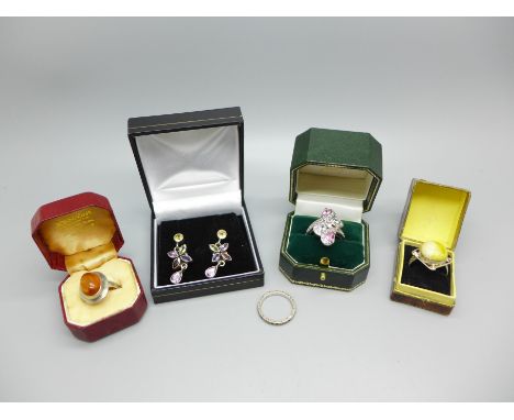 Four silver rings and a pair of silver and gem set earrings, (eternity ring lacking some marcasite), K, 2x M and N 