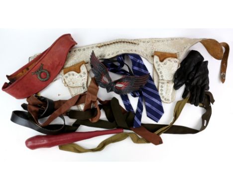 Movie props and costumes including vintage belts, gloves, leather boots, shoes, patches, badges, and accessories. Some with W