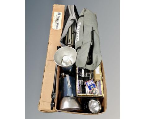 A box containing a pair of Courtenay colour flash lamps, a quantity of camera filters, a Bell and Howell projector screen and