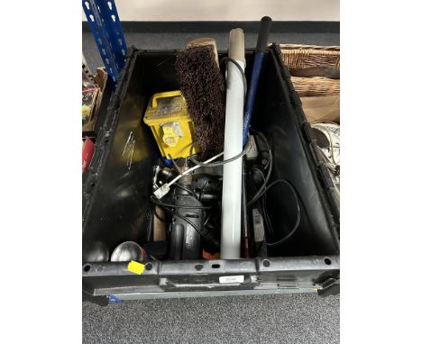 A large plastic crate containing assorted power tools, 110v transformer, hand tools, workshop light etc.