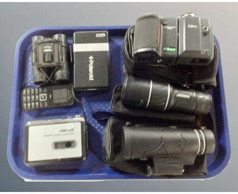 A tray containing a Nikon camera, Panda field glasses, two spotting scopes, cassette Walkman.