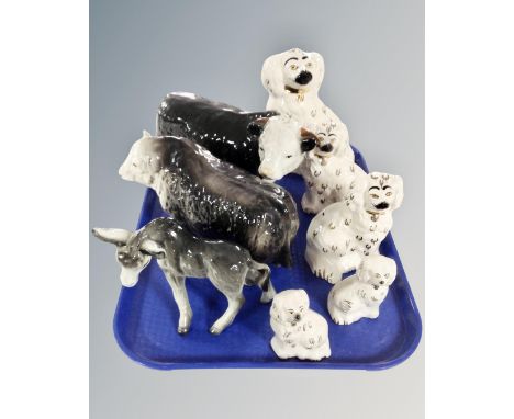 A tray containing two pairs of Staffordshire spaniel figures, together with a further spaniel figure, a ceramic donkey figure
