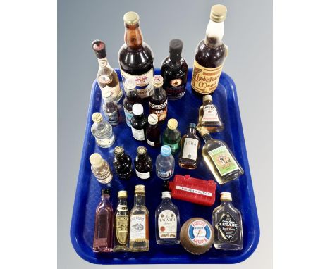 A tray containing alcohol miniatures including whiskey, gin, Bacardi, rum etc. together with three further bottles containing