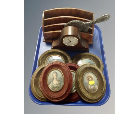 A tray containing six framed portrait miniatures of ladies, a metal embossed hand mirror, a letter rack and a Comitti of Lond