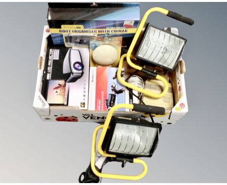 A box containing a pair of work lights, a car boot organizer, a mini LED projector, an Agfa video camera etc.