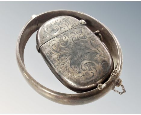 An engraved silver bangle together with a silver vesta case.