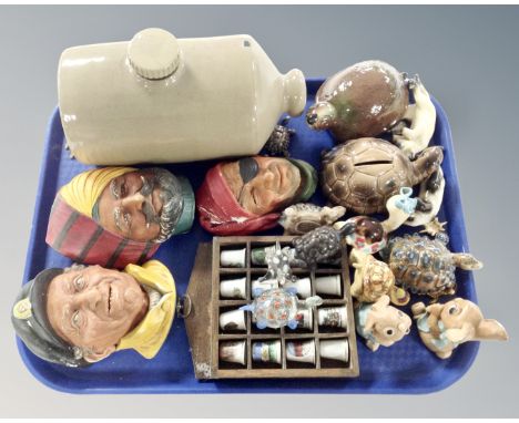 A tray containing stoneware, hot water bottle, china thimbles on stand, Wade tortoises, Bossons wall plaques etc.