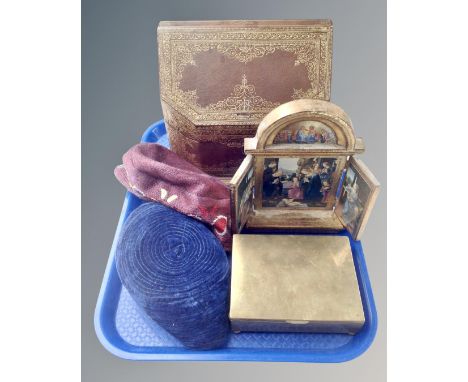 A tray containing a leather bound desk box, folding religious icon, brass cigarette box, two African Kufi hats.