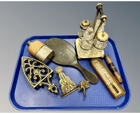 A hip flask, a plated cruet, a thermometer, hand mirror, brass trivet, brass bird ornament etc (One tray)