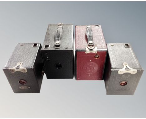 Four vintage boxed brownie cameras.