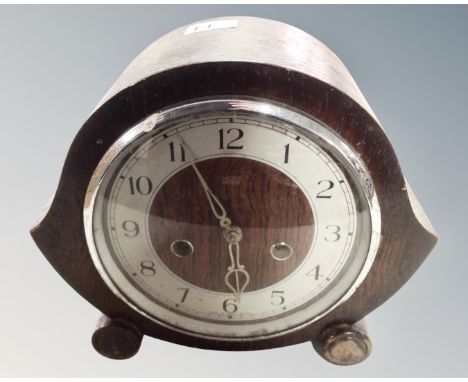 A 1930s oak cased eight-day mantel clock.