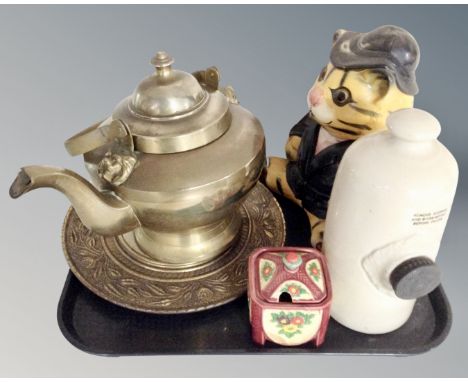 A tray containing a brass lion mask teapot together with a brass embossed plaque, stoneware hot water bottle, novelty cookie 