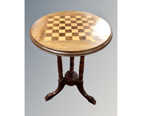 A 19th century circular mahogany chessboard topped occasional table on carved beech legs.