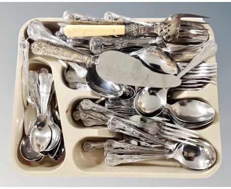 A plastic cutlery tray containing a set of stainless steel cutlery, together with a silver handled pie server.