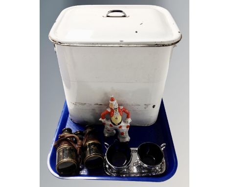 A tray containing a vintage enamelled lidded bread bin, a ceramic figure of a clown, a pair of antique leather bound field gl
