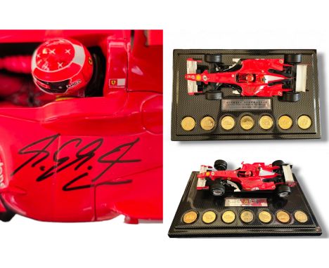 MINICHAMPS F1 1/18 Ferrari Michael Schumacher signed model with 7 Commemorative Coins, limited edition 311/1000. Good conditi