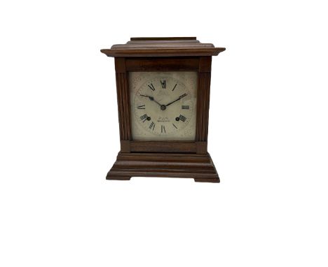 An American Mantle clock in a mahogany case with an eight-day “Ansonia” striking movement, case with a flat top and reeded pi