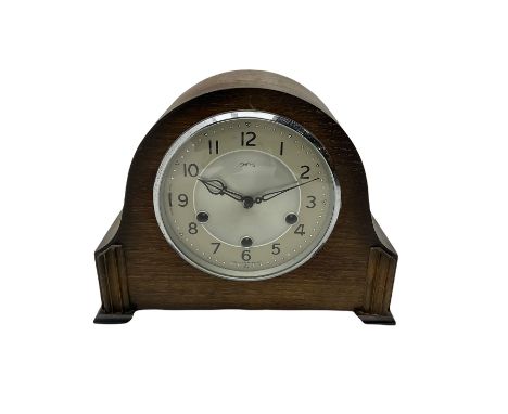 A 1930's Westminster chiming mantle clock in an oak case, with a two-piece silver effect dial, Arabic numerals and minute mar
