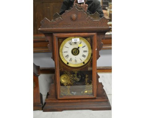 A late 19th century American gingerbread clock by Seth Thomas Clock Company, Connecticut, with enamel dial with roman numeral