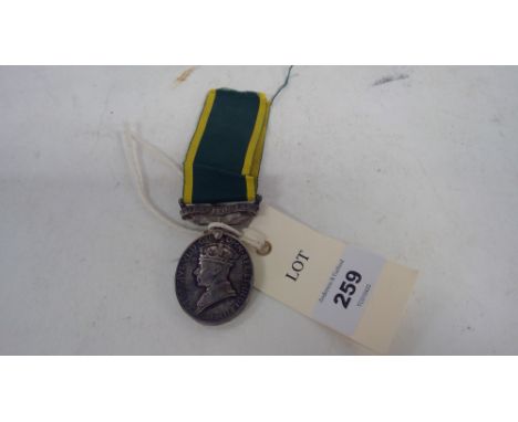 A WWII Territorial Army Medal and ribbon, stamped '922459 SJT. N. ROWAN. R.A.