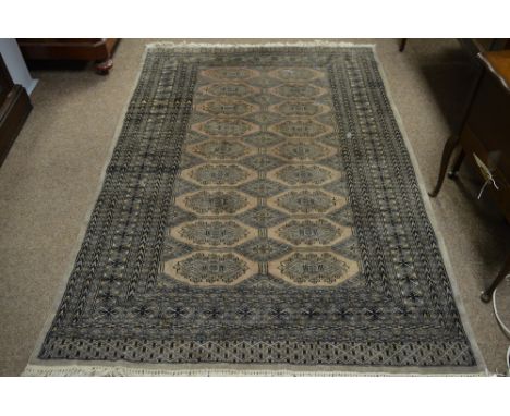 An early 20th century bokhara rug. with light brown ground with two columns of nine guls enclosed in a geometric border. 182 