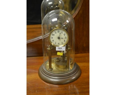 A 20th century German anniversary clock, the enamel dial with Arabic numerals, brass and torsion pendulum case raised on a pa