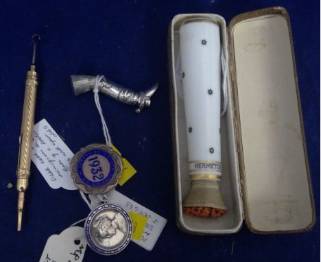 A German porcelain stamp moistener, marked 'Hermetos'; a white metal leg and boot pattern desk seal, with engraved initials; 