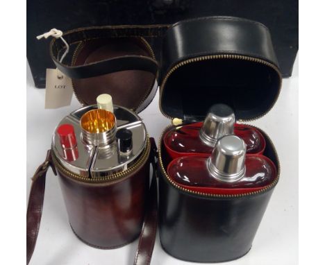 A German leather cased flask and cup set; together with another two flask set in leather case, one marked Gin..