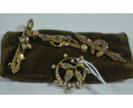 Edwardian brooches, including: a seed pearl crescent and acorn brooch; a seed pearl and ruby bar brooch; a blue stone brooch;