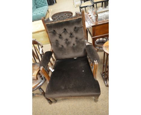 A gent's Victorian open arm easy chair, the seat, back and arms upholstered in brown velour, raised on turned legs with ceram