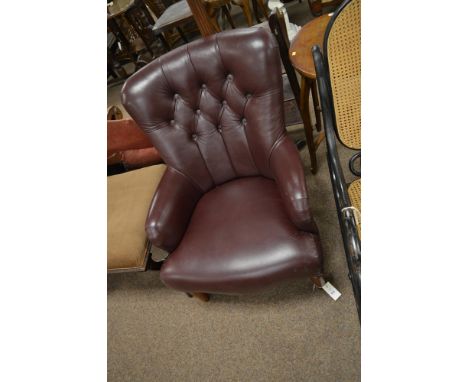 A 20th century faux leather upholstered open arm chair, with curved top and deep button back above out-swept and padded seat 