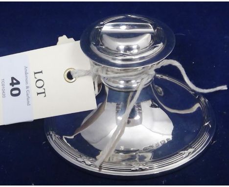 A silver inkwell, by Herbert Bushell, Birmingham 1913, with ribbon and pole design and quill rest to cover.