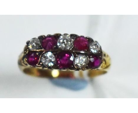 A ruby and diamond ring, set with five circular facet cut rubies and five old cut diamonds weighing a total of approximately 